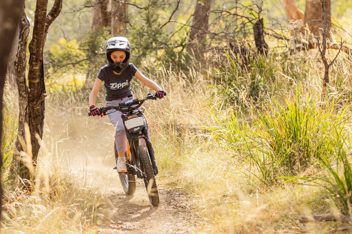 girl riding rebel ebike through bush