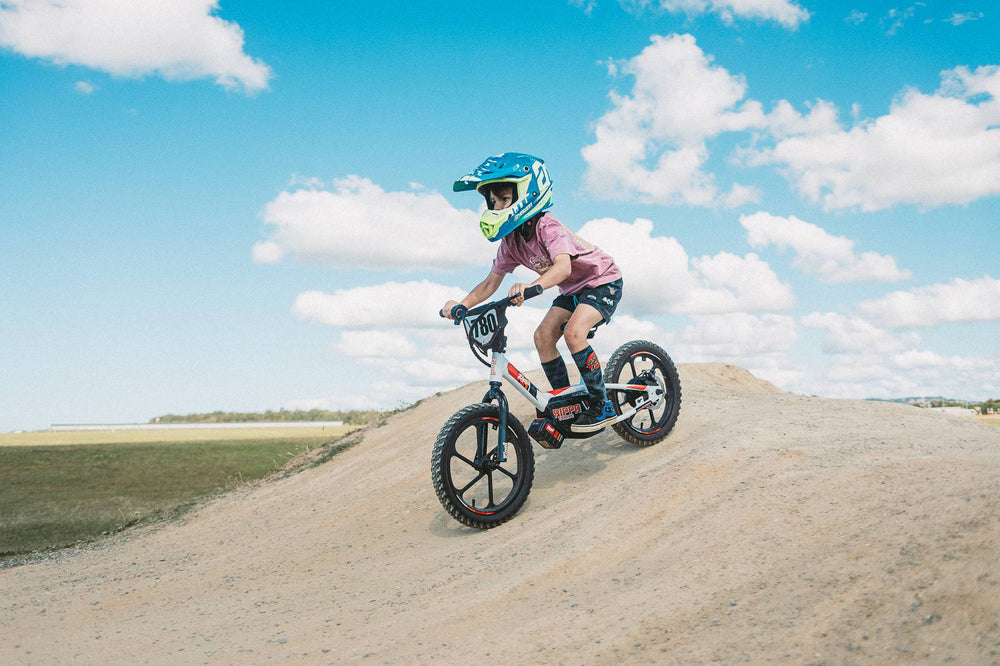 Son at pump track riding rippa 16 balance bike