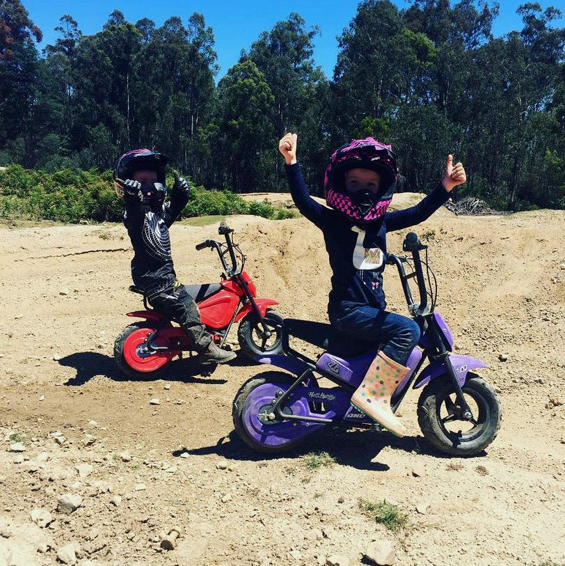 Kids riding prototypes on gravel.