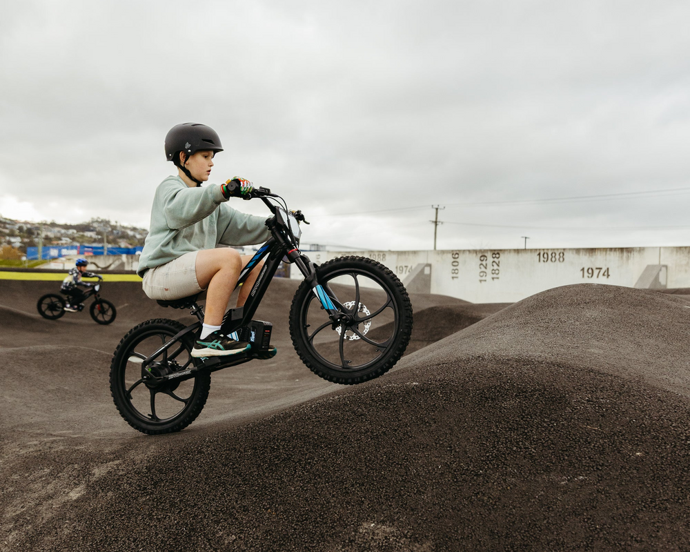 kid on electric bike at pump track