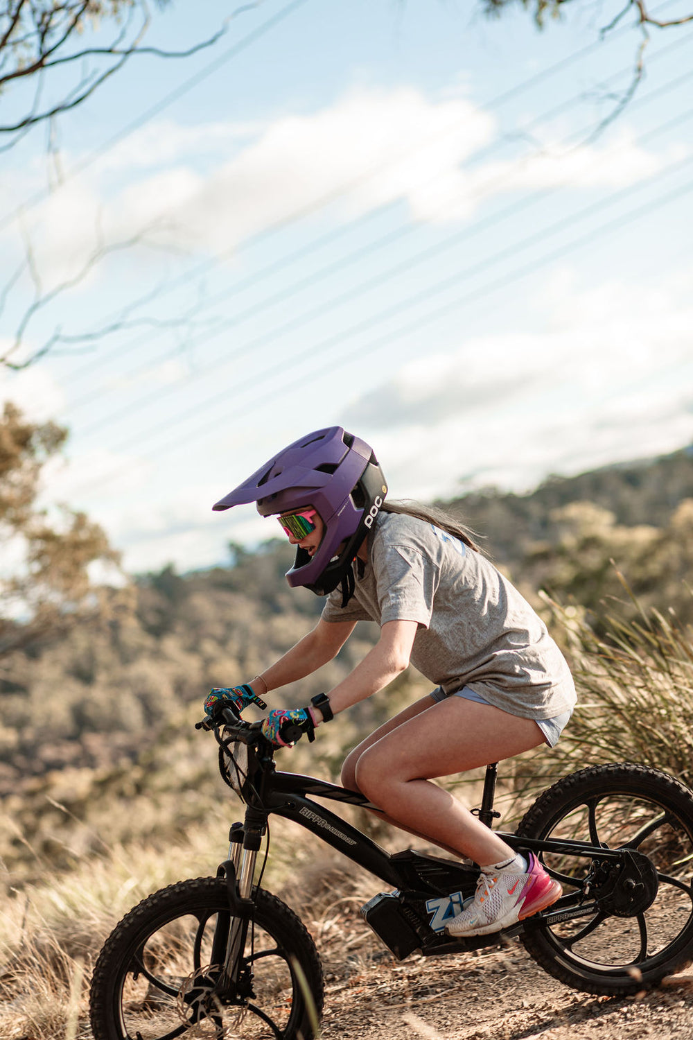 girl riding rippa 20" with helmet on  balance bike