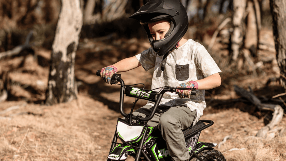 young boy on zippi ride 10" with helmet on