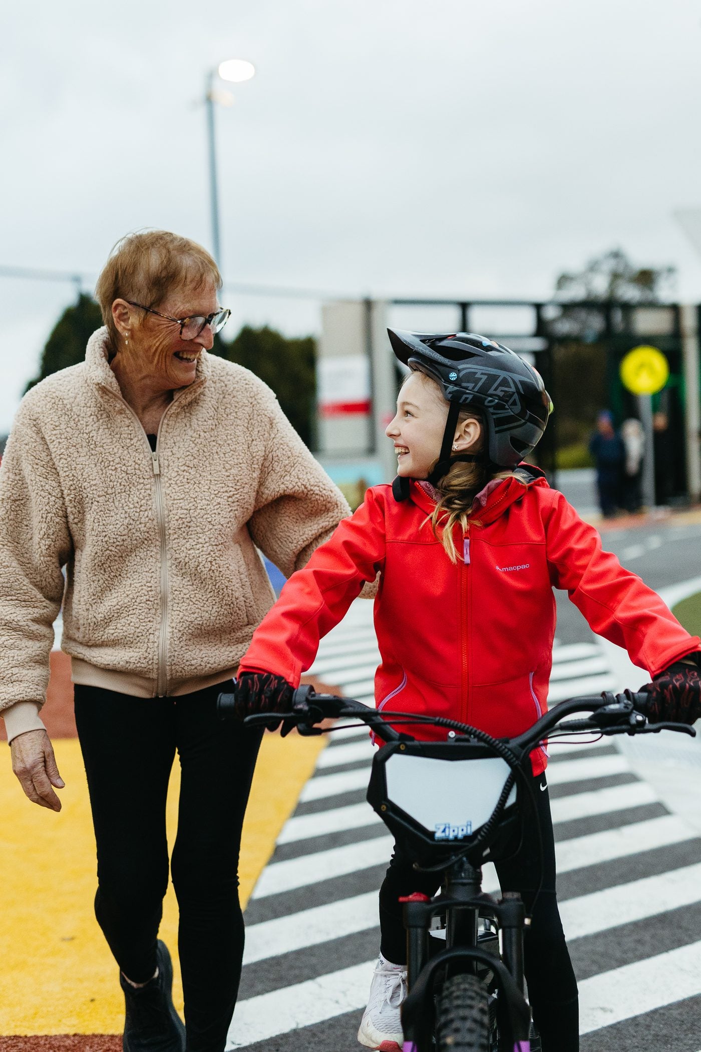 Grandmother walking alongside her granddaughter on a Zippi Rippa.