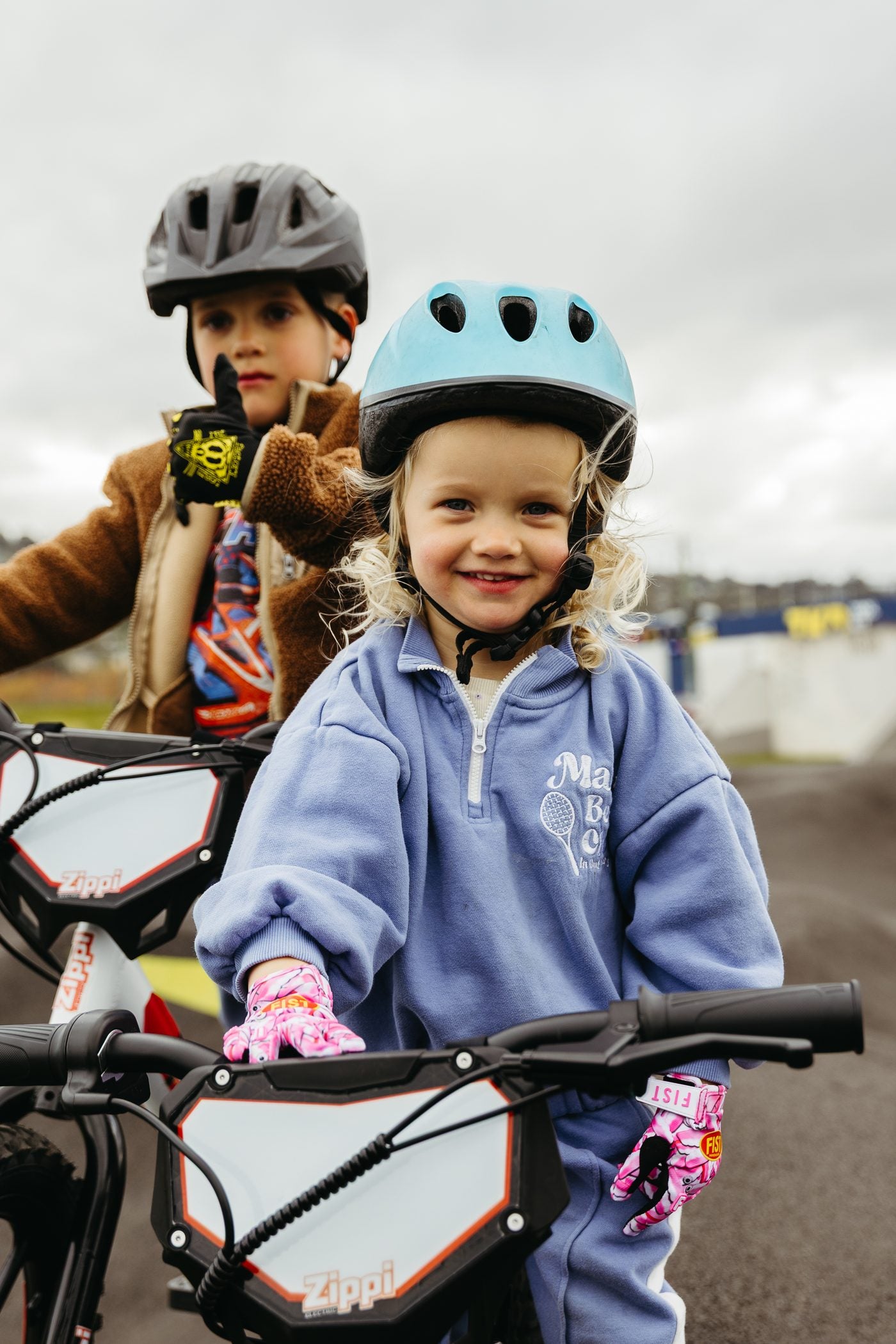 Two sisters on Zippi Rippa 12 inch bikes on a pump track.