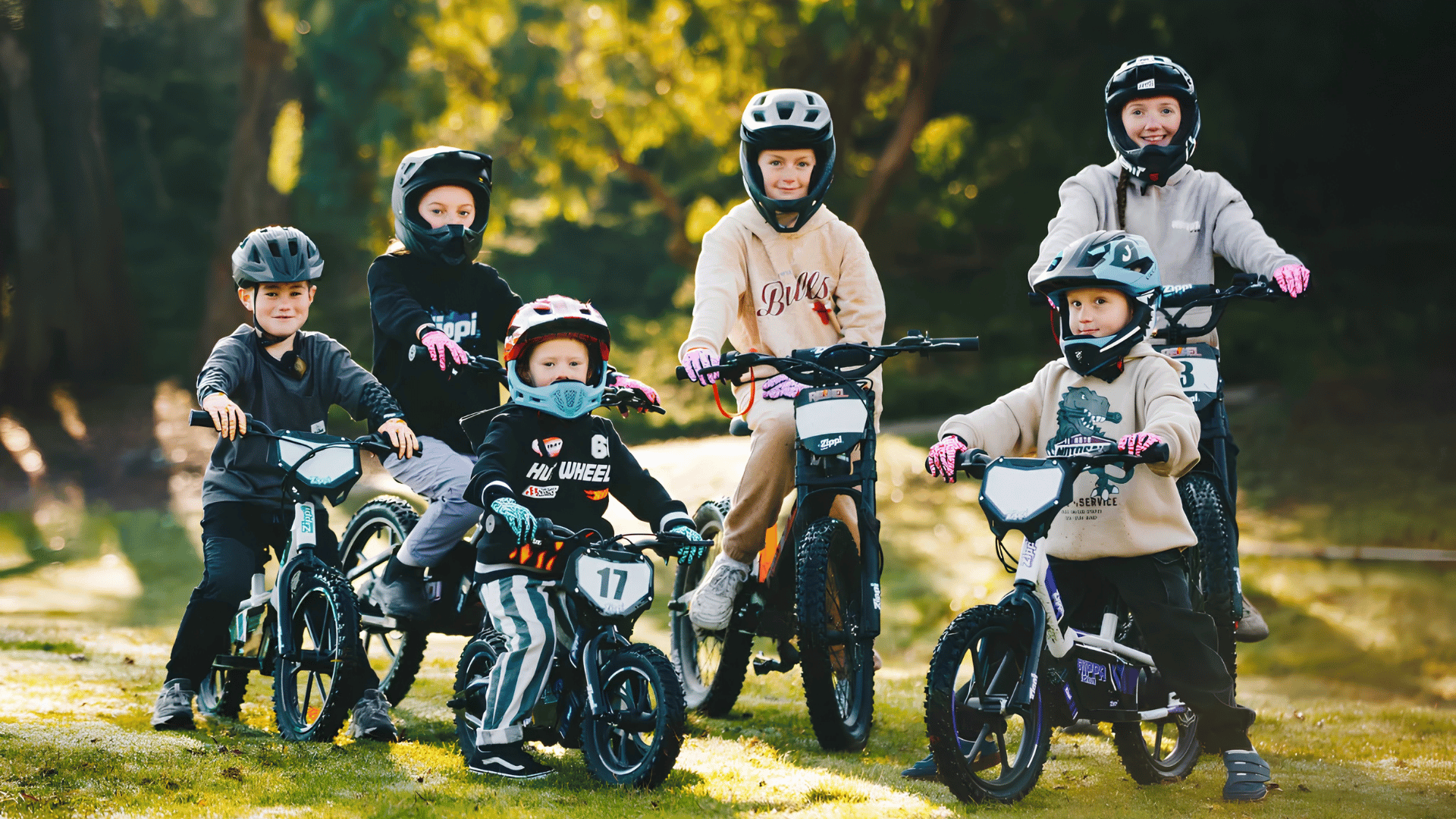 Three kids riding three sizes of Zippi bike on the riverside in Tasmania.